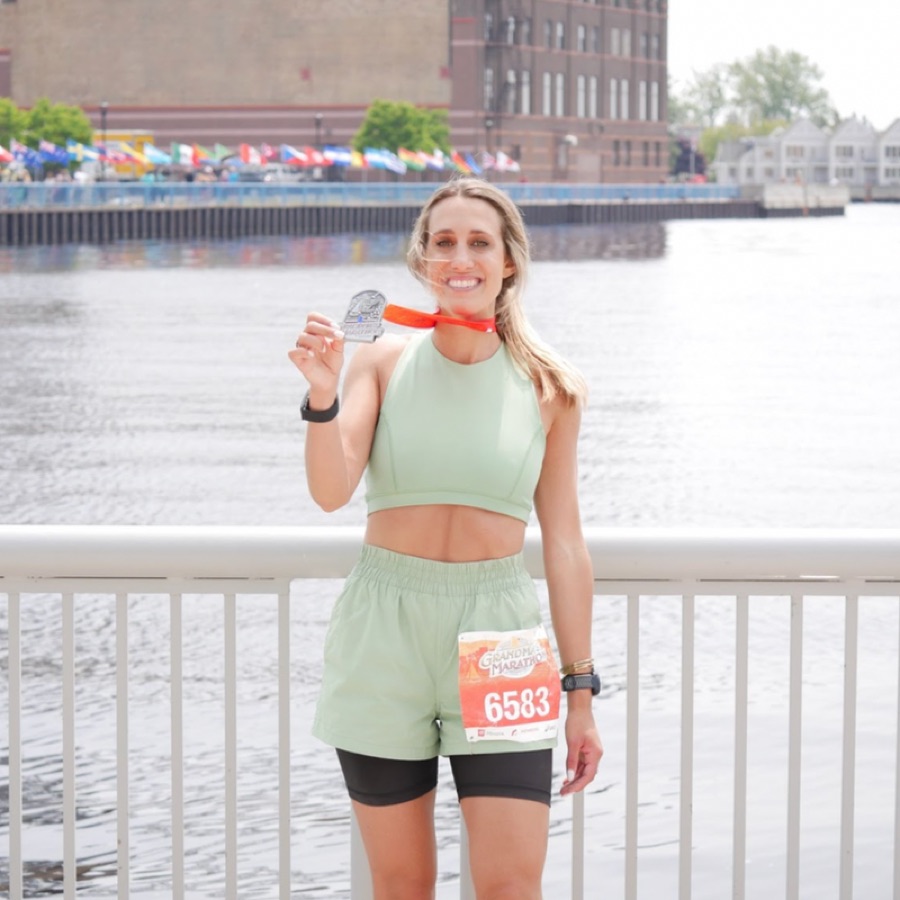 KTP athlete with a Grandma's Marathon finisher medal
