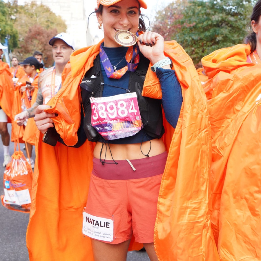 KTP athlete with medal and poncho after the NYC Marathon