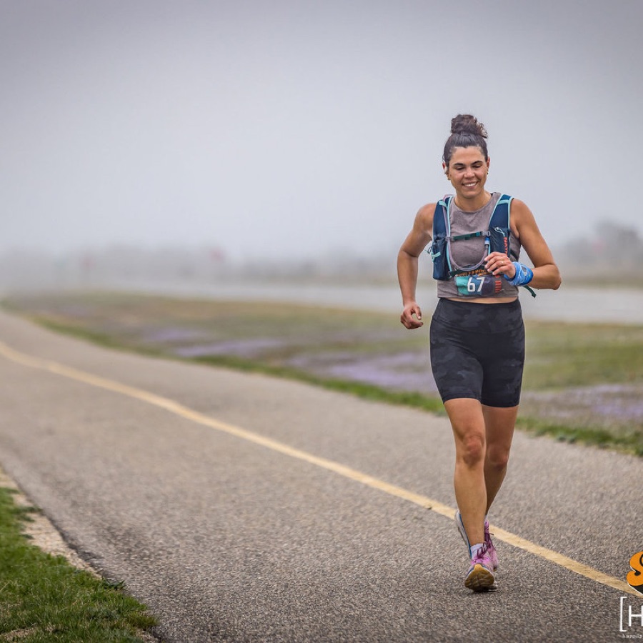 KTP athlete running an ultra on a foggy waterfront path